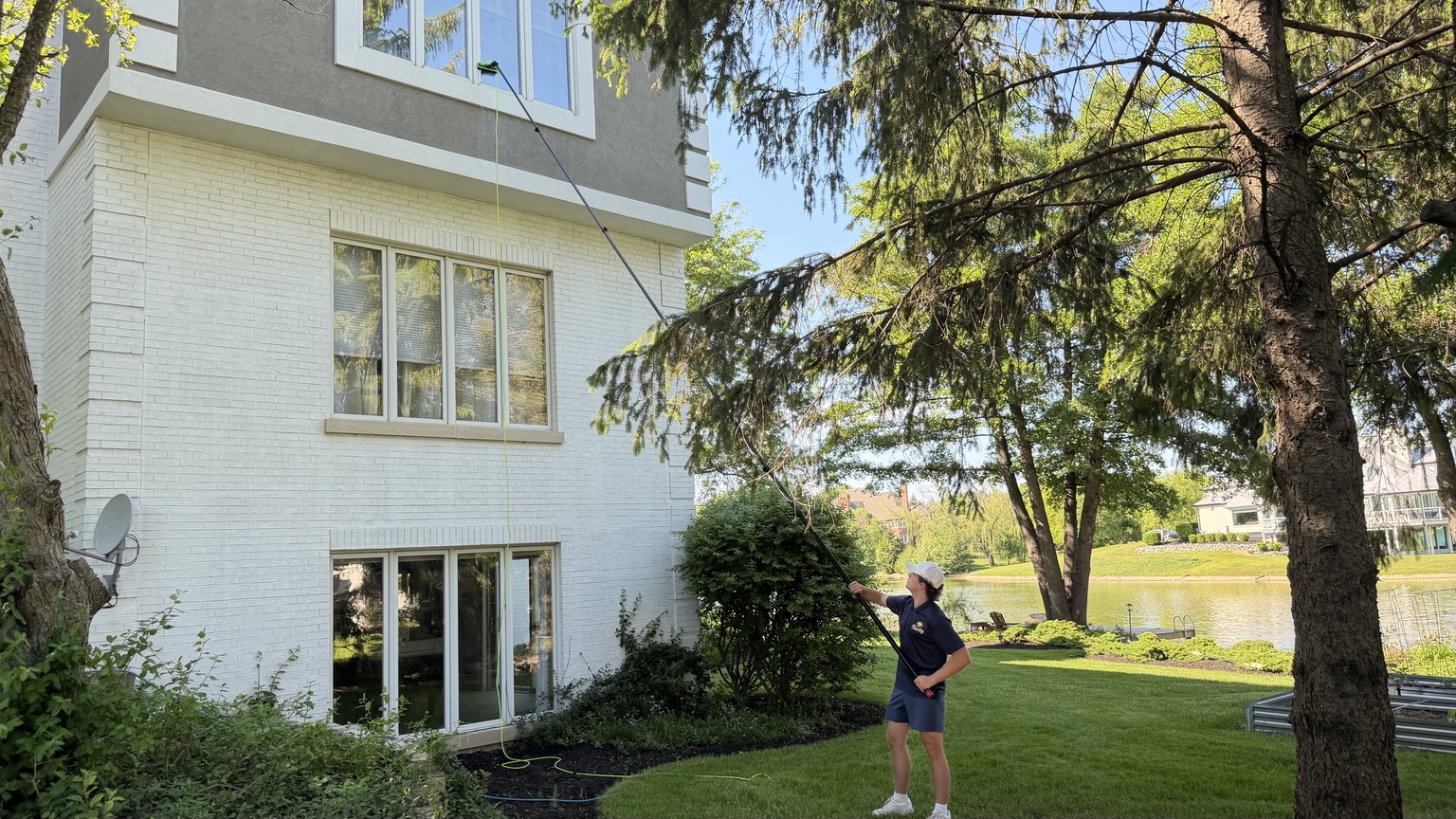 Professional cleaning a bright sunny window